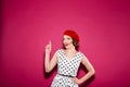 Cheerful surprised ginger woman in dress with arm on hip Royalty Free Stock Photo