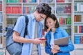 Cheerful talking college students male and female inside library Royalty Free Stock Photo