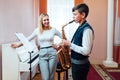 Cheerful teacher with student boy learning saxophone lessons at school Royalty Free Stock Photo