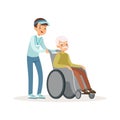 Cheerful teen boy pushing old man on wheelchair. Disability assistance. Kid volunteer in blue cap, shirt and jeans