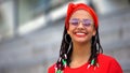 Cheerful teen girl with fashionable accessories smiling into camera, hipster