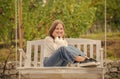 cheerful teen girl having free time outside on swing, relaxation Royalty Free Stock Photo