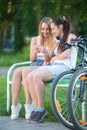 Cheerful teenage biker girls using cellular phone Royalty Free Stock Photo