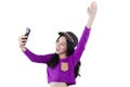 Cheerful teenage girl holds cellphone Royalty Free Stock Photo