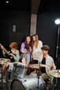 cheerful teenage girls singing while boys Royalty Free Stock Photo