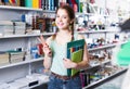 Teenager buying different products in stationery shop