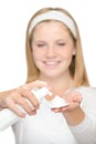 Cheerful teenager girl using cleaning foam cream