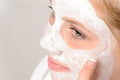 Cheerful teenager girl using face mask cleaning