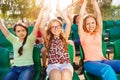 Cheerful teenagers hold arms up during game Royalty Free Stock Photo