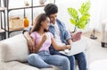 Cheerful teenagers using laptop together at home Royalty Free Stock Photo