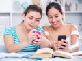 Cheerful teens girls chatting on phones