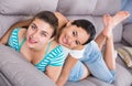 Cheerful teens girls laughing on couch