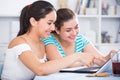 Cheerful teens girls using laptop