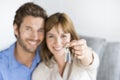 Cheerful thirty year old couple showing a keys of their new apartment Royalty Free Stock Photo