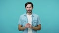 Cheerful thoughtful bearded guy in jeans shirt dreaming with inspired happy expression fantasizing and pondering plan