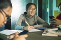 Cheerful three asian teenager doing school work in home living room