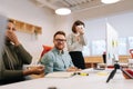 Cheerful three diverse young man and women talking working in teamwork together at computer. Happy African and Caucasian Royalty Free Stock Photo