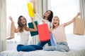 Cheerful three girlfriends with many shopping bags