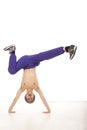 Cheerful topless young man sitting on his hands upside down Royalty Free Stock Photo