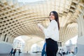 Cheerful tourist woman on vacation in Andalusia, visiting Setas de Sevilla- Metropol Parasol at the La EncarnaciÃÂ³n square in Royalty Free Stock Photo