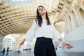 Cheerful tourist woman on vacation in Andalusia, visiting Setas de Sevilla- Metropol Parasol at the La EncarnaciÃÂ³n square in Royalty Free Stock Photo