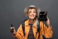 Cheerful traveler holding vintage camera and