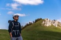 Cheerful traveler posing in the background of Rarau Mountains, Romania