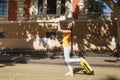 Cheerful traveler tourist woman in yellow summer casual clothes, hat with suitcase city map walk in city outdoor. Girl Royalty Free Stock Photo