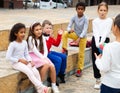 Cheerful tweens spending time together on city street