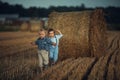 Cheerful twin brothers running on the farmland Royalty Free Stock Photo