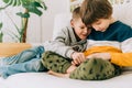 Cheerful two Childs boys playing online game, watching video on cellphone. Smiling kids using funny mobile apps Royalty Free Stock Photo