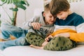 Cheerful two Childs boys playing online game, watching video on cellphone. Smiling kids using funny mobile apps Royalty Free Stock Photo