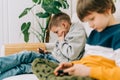 Cheerful two Childs boys playing online game, watching video on cellphone. Smiling kids using funny mobile apps Royalty Free Stock Photo