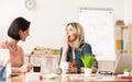 Cheerful two ladies are gossiping in office Royalty Free Stock Photo