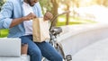 Cheerful Unrecognizable Afro Guy Unwrapping Paper Bag With Lunch Outdoors Royalty Free Stock Photo