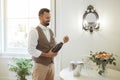 Cheerful Waiter Man Opening Bottle Of Wine In Hotel Room Royalty Free Stock Photo