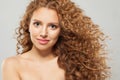 Cheerful wavy hair woman. Young fashion model with long curly hairstyle and natural fresh clear skin posing on white background Royalty Free Stock Photo