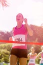 Cheerful winner athlete crossing finish line Royalty Free Stock Photo