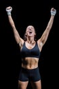 Cheerful winning athlete against black background Royalty Free Stock Photo