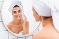 young beautiful woman near mirror on Royalty Free Stock Photo