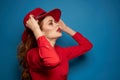 cheerful woman attractive look posing red hat blue background Royalty Free Stock Photo