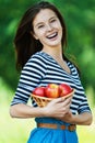 Cheerful woman basket apples