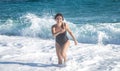 Cheerful woman in a bathing suit runs by the sea Royalty Free Stock Photo