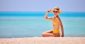 Cheerful woman in beach wear on sandy shore Royalty Free Stock Photo