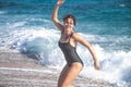 Cheerful woman in a bathing suit runs by the sea Royalty Free Stock Photo