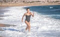 Cheerful woman in a bathing suit runs by the sea Royalty Free Stock Photo