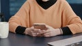 Cheerful woman browsing internet on smartphone at desk Royalty Free Stock Photo