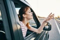 Cheerful woman in car trip journey road