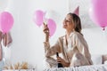 Cheerful woman with champagne celebrating birthday