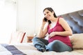 Pregnant Woman Using Smartphone On Bed Royalty Free Stock Photo